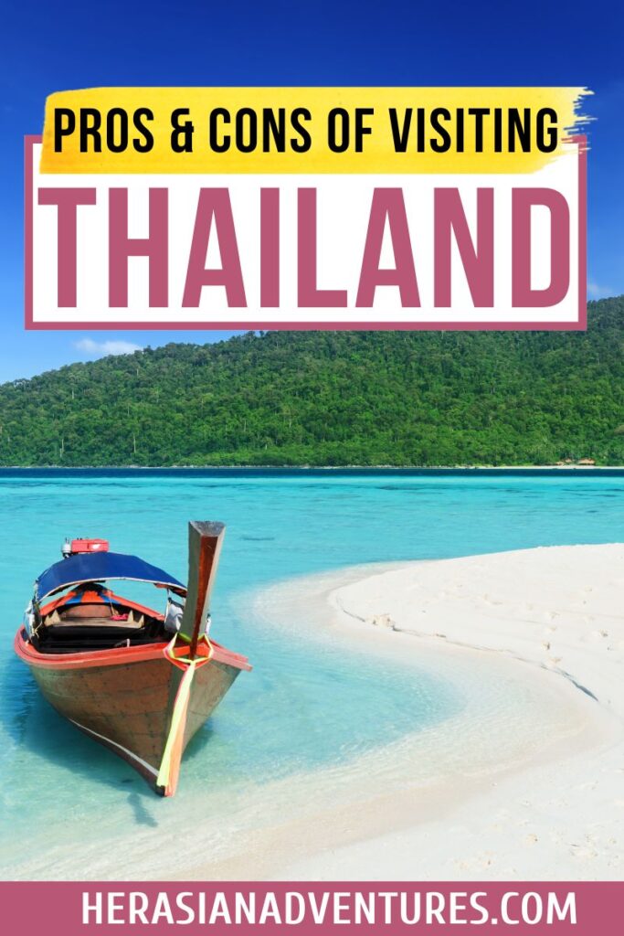 "Pros & cons of visiting Thailand" text overlay on an image of a long-tail boat on a white sandy beach with crystal clear waters. One of the top reasons to visit Thailand is its breathtaking beaches, though some travelers may weigh the pros and cons before deciding if Thailand is worth a visit.