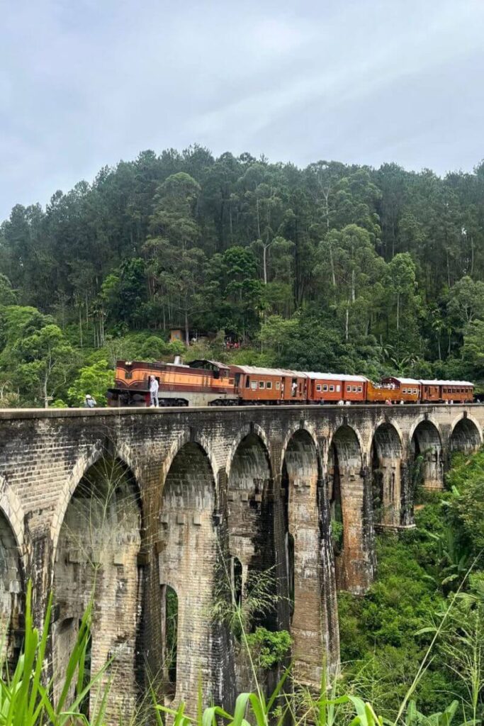 A scenic photo of the famous Nine Arches Bridge in Ella, Sri Lanka, with a train crossing and lush jungle backdrop—highlighting tips for solo travel in Asia and how to convince your parents to let you go somewhere unforgettable.