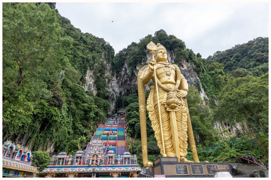 The Batu Caves with the large golden statue and colorful steps in Malaysia. How do you get to Singapore from KL? A flight takes about an hour.