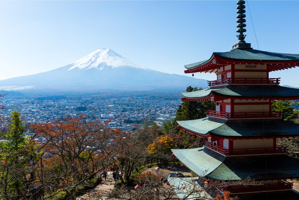 stunning view of Mount Fuji with a traditional red pagoda in the foreground, surrounded by autumn leaves. This iconic Japan landscape is a must-see fall destination, perfect for scenic photography and cultural trips during Japan’s fall season.