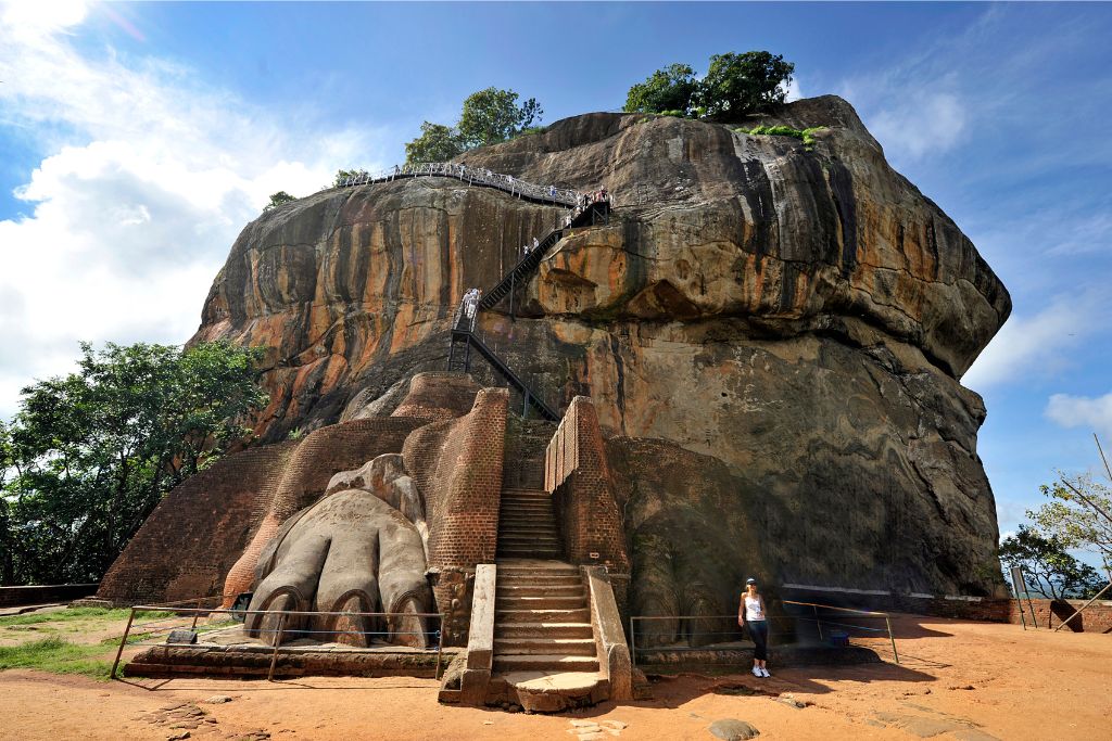 Sigiriya Rock Fortress, a UNESCO World Heritage Site in Sri Lanka, with steep stairs leading to the top. This is a must-see destination for travelers exploring the history of Sri Lanka and its natural wonders.