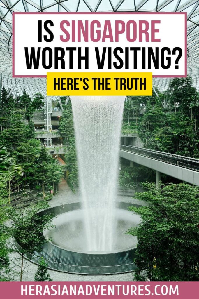 Singapore’s indoor waterfall at Jewel Changi Airport cascades into a lush garden under a glass dome, overlaid with bold text reading “Is Singapore Worth Visiting? Here's the Truth.” This iconic airport attraction highlights why Singapore is worth seeing, even if you're just on a layover.