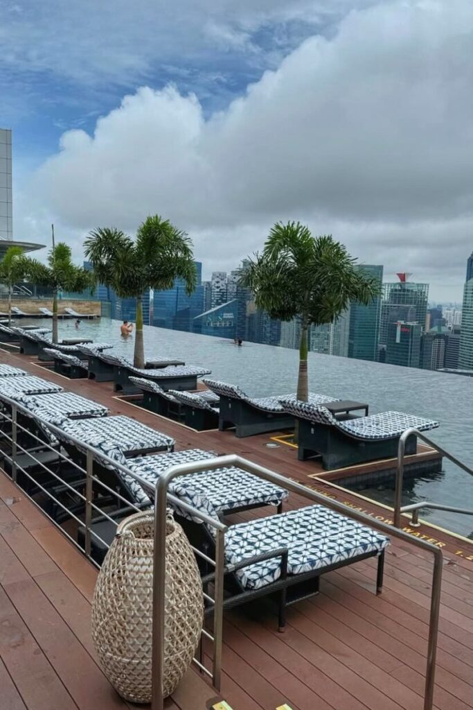 Poolside loungers line the edge of the famous Marina Bay Sands infinity pool, with panoramic views of Singapore’s skyline. This luxury rooftop experience is one of the most Instagrammable and convincing reasons why Singapore is worth visiting.