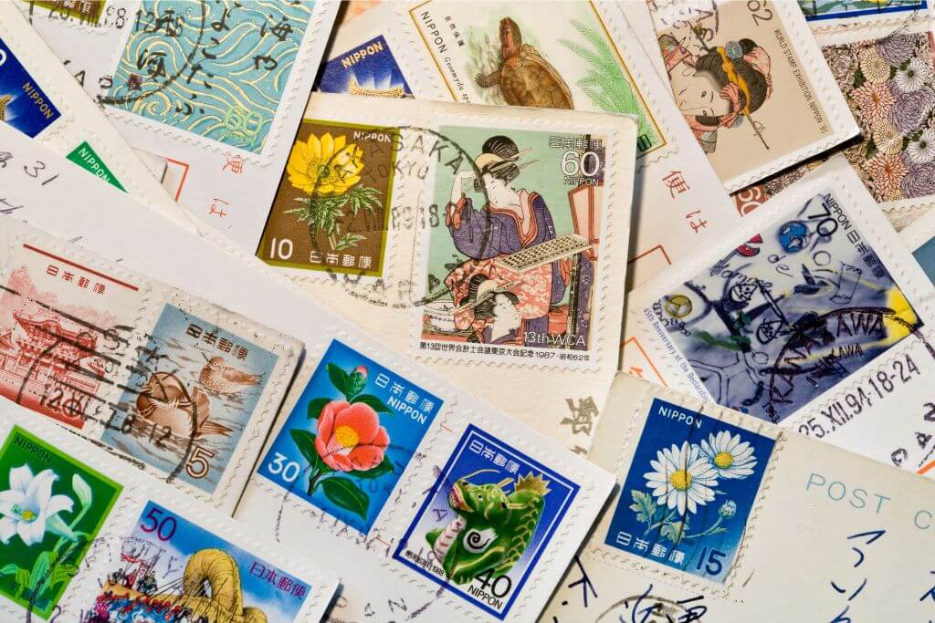 A collection of colorful Sri Lankan postage stamps, some with floral and animal designs, showcasing the island's heritage. These stamps are ideal for collectors as unique Sri Lanka souvenirs.