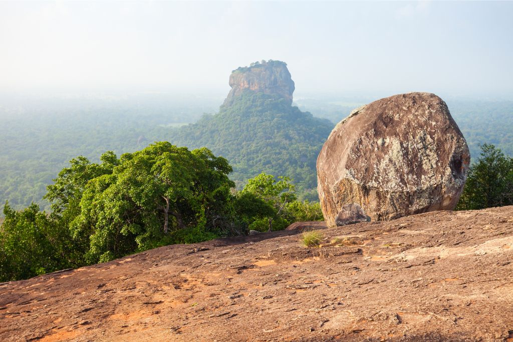 Distant view of Sigiriya Rock amidst greenery, capturing why the best season to visit Sri Lanka includes exploring natural landmarks.