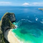 A breathtaking view of turquoise waters and dramatic cliffs at Nusa Penida, Indonesia, an idyllic spot for Southeast Asia tourism and a top pick for a bucket list Southeast Asia adventure.