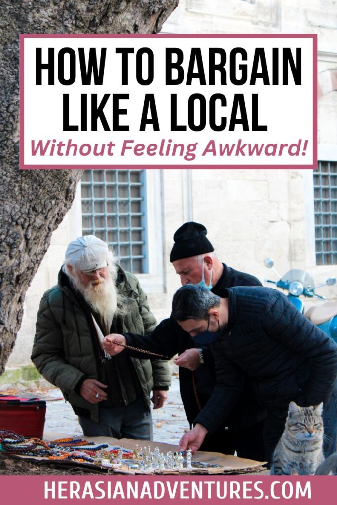 A bearded street vendor in a green coat negotiates with a buyer over beaded jewelry at an outdoor market. The text on the image says "how to bargain like a local without feeling awkward!". Mastering how to bargain like a local can help you navigate markets with confidence. Follow these haggling tips to avoid feeling awkward.