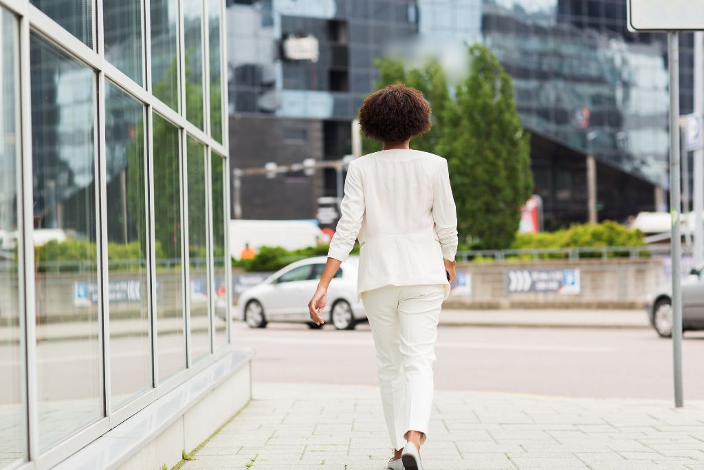 A confident woman walking in an urban setting, symbolizing the art of negotiation and tips for traveling in Europe with financial savviness