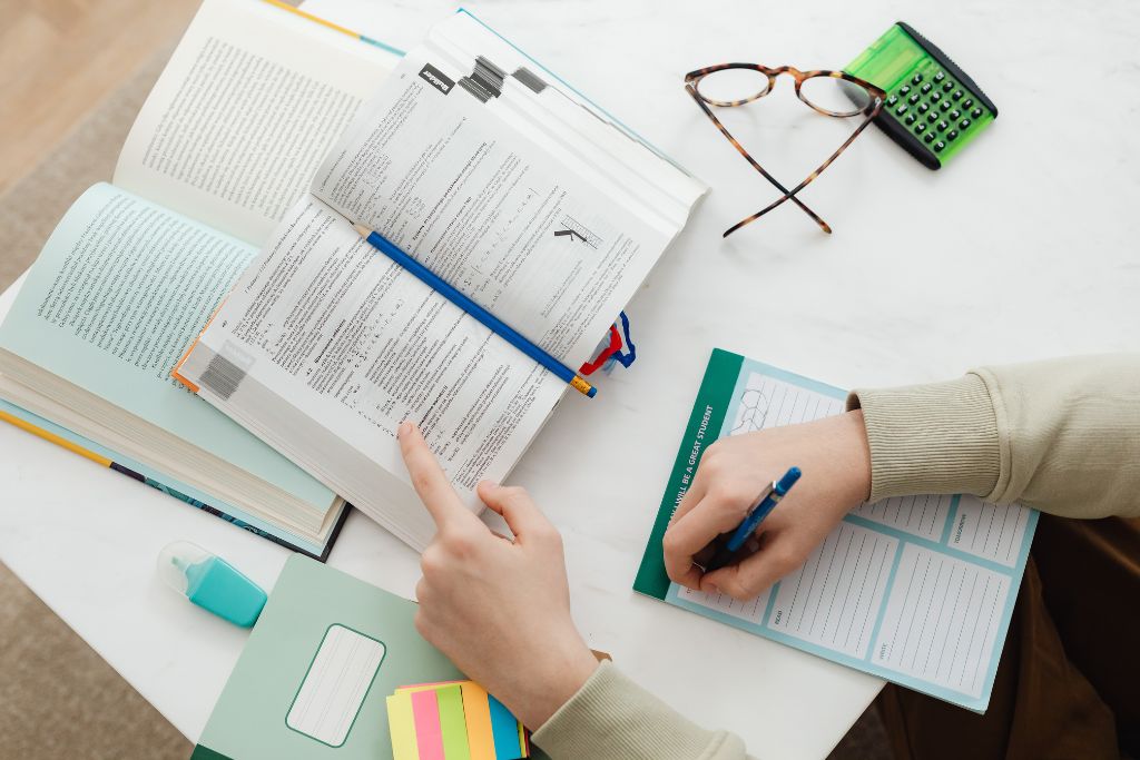 study table with open books, notes, and a calculator, reflecting preparation for learning about Egypt's historical and religious sites, including mosques and Islamic culture. This image highlights tips for exploring Egypt’s religious history and landmarks.