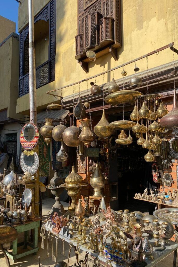 A vibrant display of brass and copper wares at a market in Coptic Cairo, capturing the blend of religious history and cultural charm in Old Cairo walking tours.