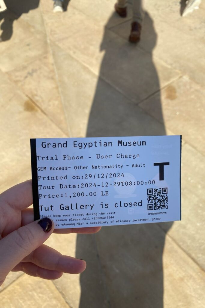 A close-up of a Grand Egyptian Museum tickets receipt, indicating a trial phase entry price and mentioning that the Grand Egyptian Museum King Tut exhibit is currently closed.