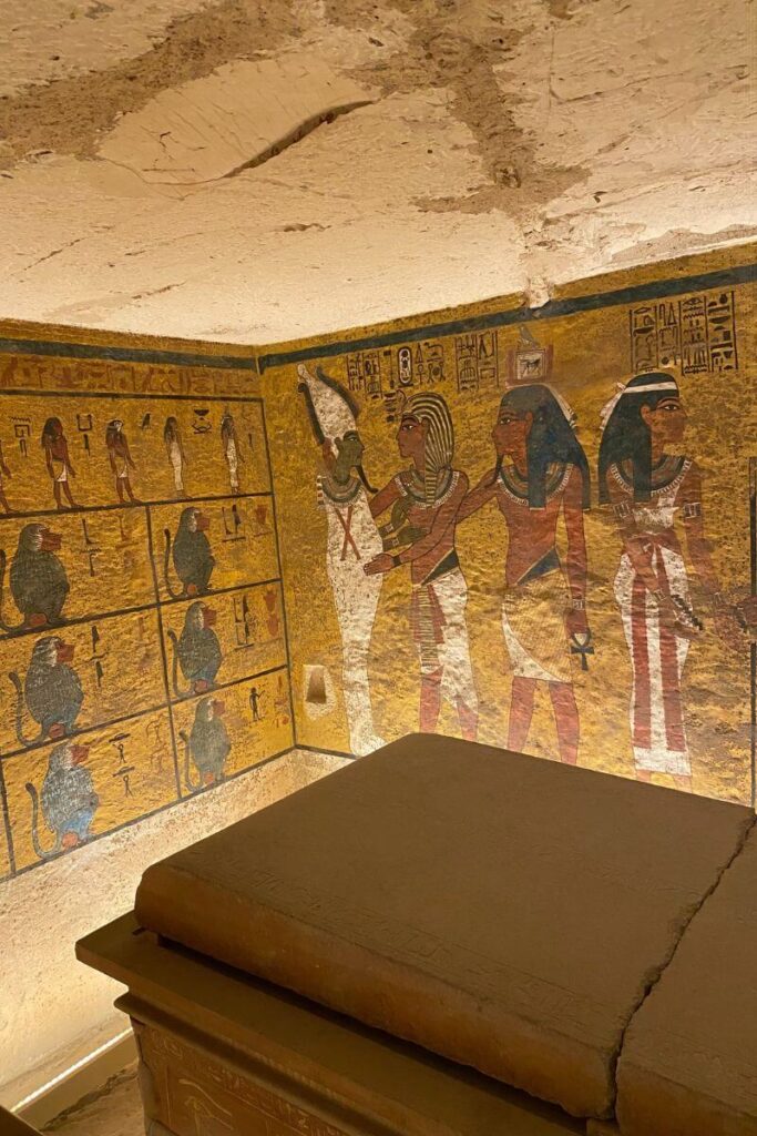 Interior of an ancient Egyptian tomb with vibrant wall paintings depicting gods and pharaohs, likely located in Luxor. Ideal for blog content comparing travel methods like Uber in Luxor Egypt versus traditional tours, or for readers interested in how to get Uber in Egypt while exploring historic sites.