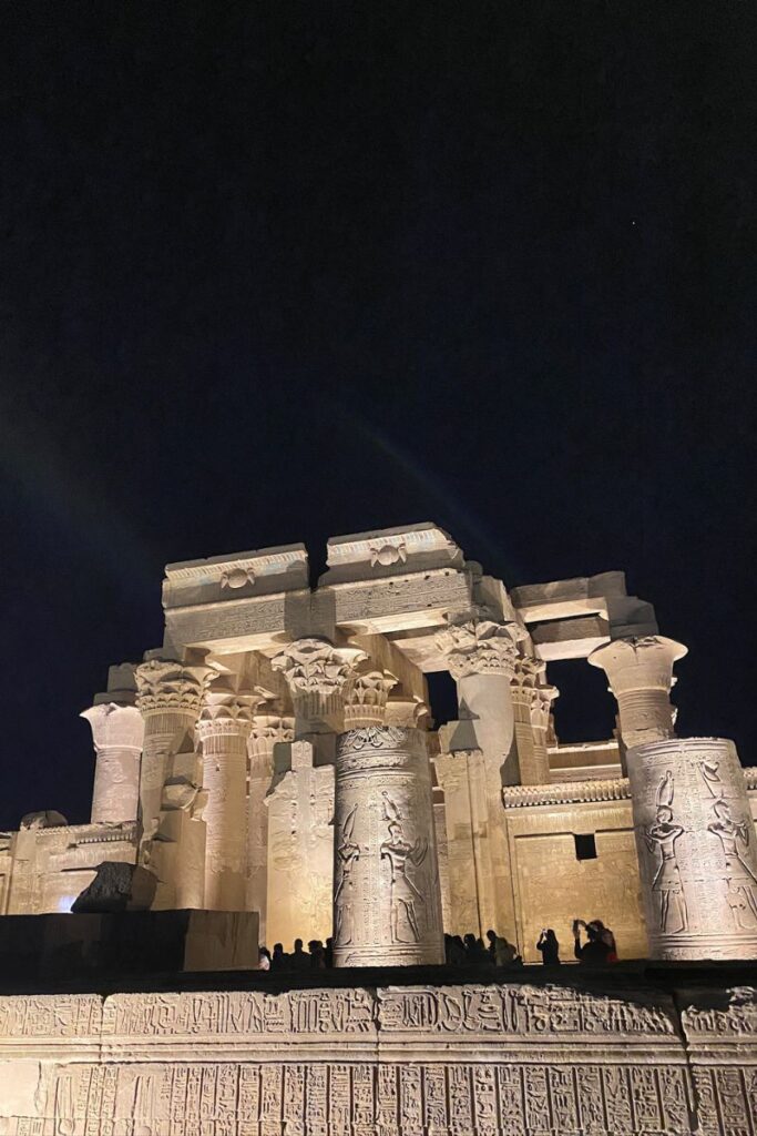 View through carved stone pillars of Kom Ombo Temple bathed in sunlight, a dual temple dedicated to Sobek, the crocodile god, and Horus the Elder, ideal for travelers exploring crocodile worship in Egypt.