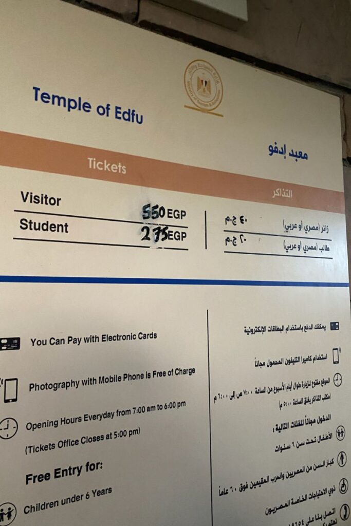 Close-up of the official ticket pricing sign at the Temple of Horus at Edfu, listing entry fees for visitors and students, along with opening hours and free entry conditions—essential info for any guide to the Temple of Horus at Edfu.