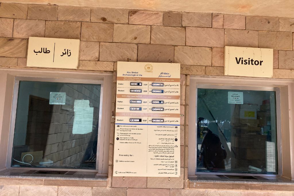 Ticket window at the Abu Simbel archaeological site with pricing info in Arabic and English, providing practical details for visitors wondering about the Abu Simbel entrance fee or planning an Abu Simbel tour from Aswan.