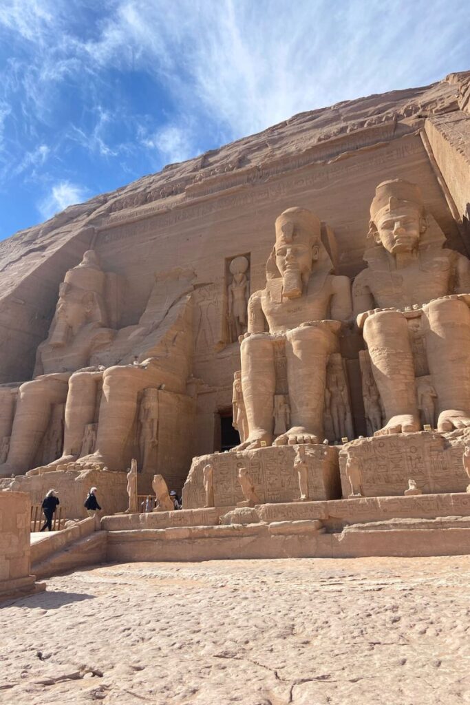 Colossal seated statues of Ramses II at the entrance of Abu Simbel temple, a must-see destination for anyone traveling from Aswan to Abu Simbel and exploring top things to do in Aswan.
