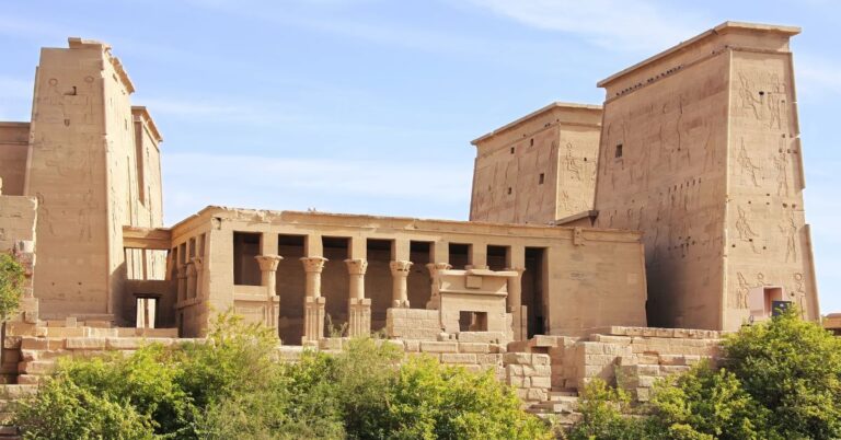 Wide-angle shot of Philae Temple Egypt showing its tall pylon towers and columned courtyard nestled on Agilkia Island. Once submerged due to the Aswan High Dam, this sacred site was relocated and now stands as a major ancient Egyptian temple and top attraction in Aswan.