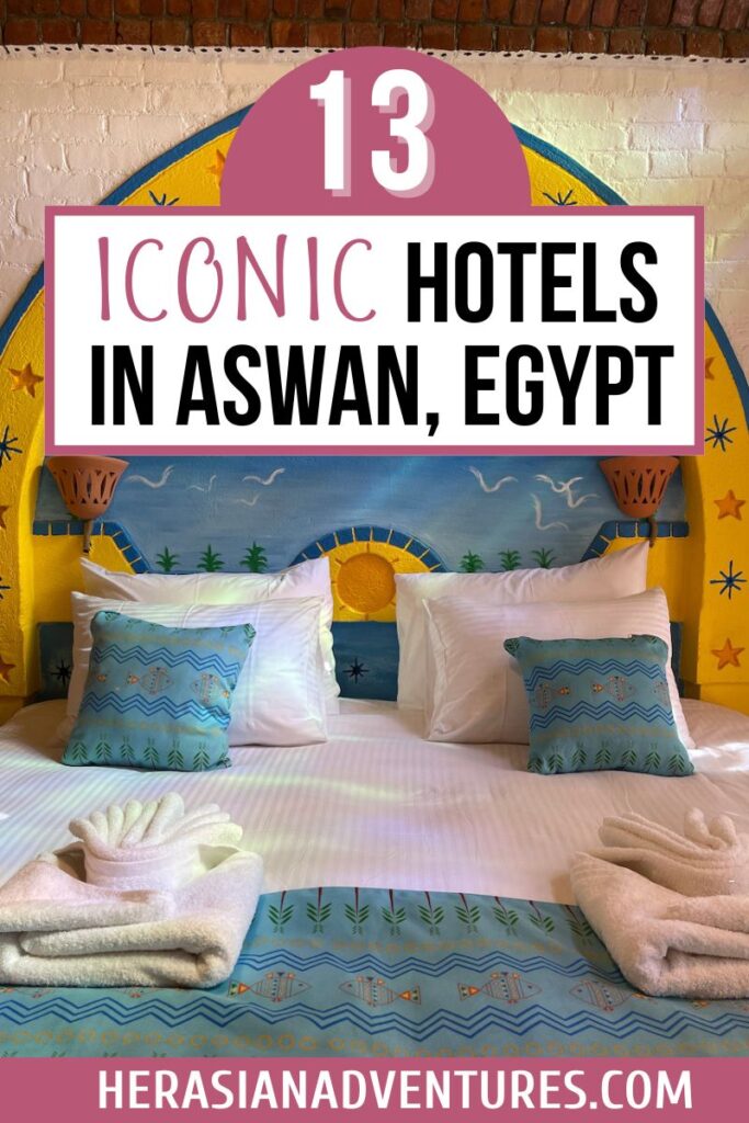 Vibrantly decorated bed with folded towels and colorful pillows beneath text that reads “13 Iconic Hotels in Aswan, Egypt,” highlighting unique places to stay in Aswan for a memorable visit.