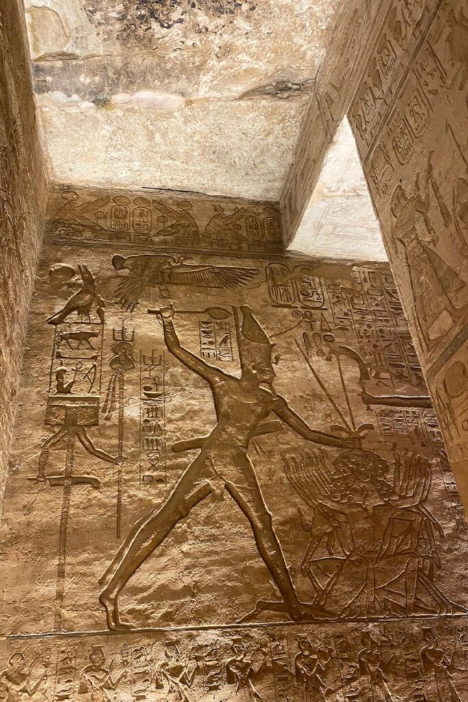 Intricate carvings inside Abu Simbel depicting a dynamic battle scene and hieroglyphs; a vivid reminder of the temple’s historical value for anyone learning how to visit Abu Simbel from Aswan or exploring Abu Simbel facts.