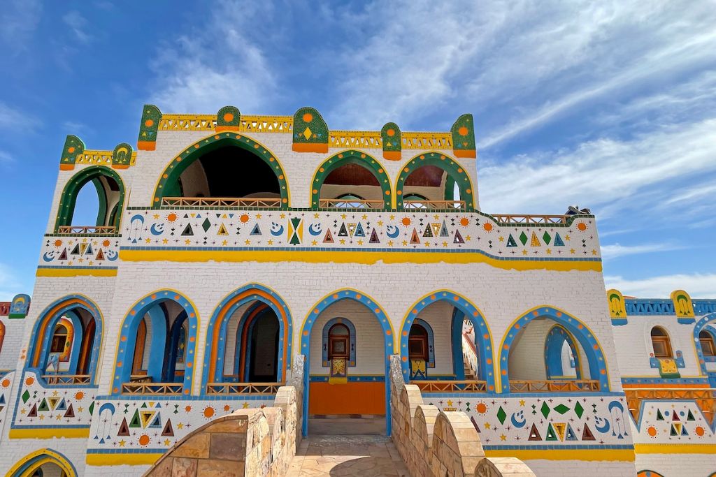 Colorful Nubian house with intricate patterns and arched windows in a Nubian village in Aswan, reflecting the vibrant culture and unique architecture of Nubian Egypt.