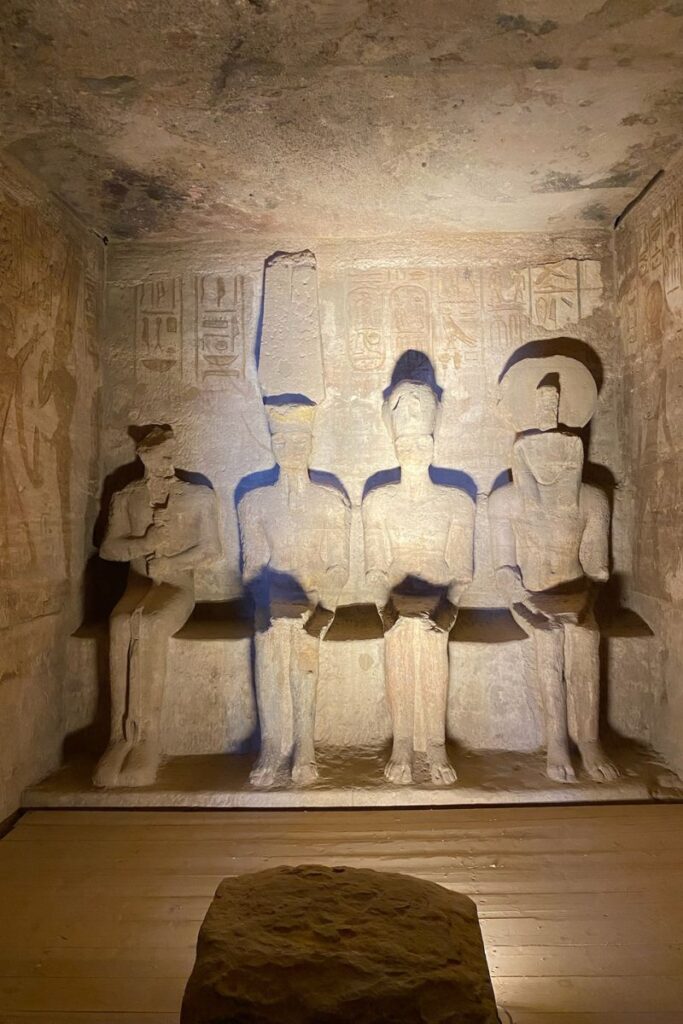 Four seated statues inside Abu Simbel’s inner sanctuary, partially lit to show detail. A key site in your Aswan travel guide and one of the top things to do in Aswan for history lovers.