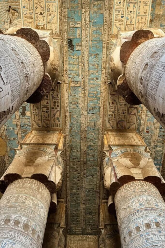 Vivid blue temple ceiling covered in celestial hieroglyphs supported by carved columns inside Dendera Temple. A top pick for unique things to do in Luxor Egypt and a visual treat beyond the typical temple itinerary.