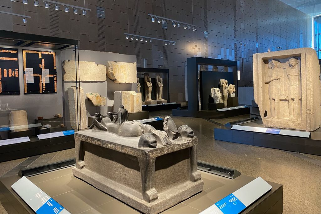 Interior of the Luxor Museum showing ancient Egyptian artifacts, statues, and sarcophagi displayed under modern lighting. A quiet, informative Luxor attraction ideal for those looking for things to do in Luxor Egypt indoors.
