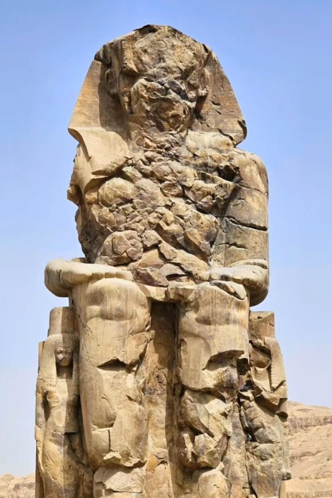 Close-up of a weathered Colossus of Memnon, one of two massive seated statues near Luxor’s West Bank. A historic and iconic Luxor attraction that’s free to visit and perfect for those exploring ancient ruins.