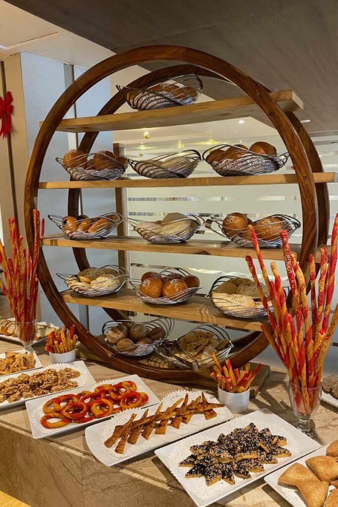 A display of assorted fresh breads, pastries, and breadsticks in the Nile cruise dining area—perfect for showcasing the all-inclusive dining experience on a Nile River cruise luxury package.
