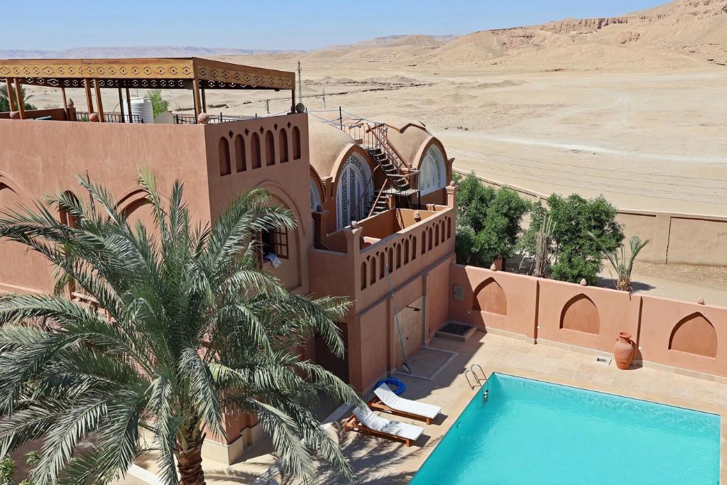 Quiet desert-side boutique hotel in Luxor’s West Bank with a turquoise pool and palm trees, a peaceful retreat among Egypt Luxor hotels with traditional charm.