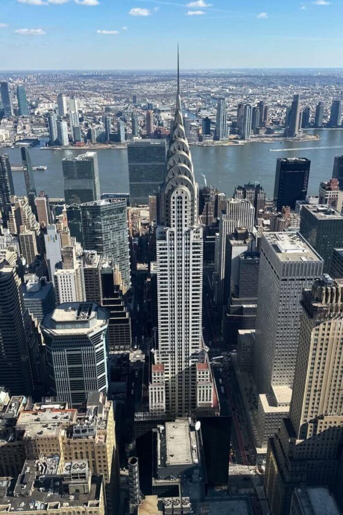 Aerial view of New York City featuring the Chrysler Building and East River skyline. Great for content on best places to travel solo female in US, traveling alone to New York, or first time traveling alone in a big city.