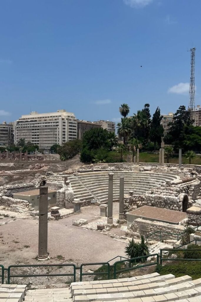 Ancient Roman amphitheater ruins surrounded by columns in Alexandria, one of the best cities to visit in Egypt. A must-see for fans of historical places to visit in Egypt and Egyptian landmarks.