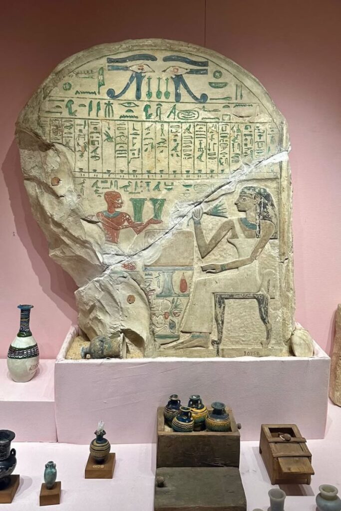 Ancient Egyptian stone stele with colorful hieroglyphics and carved figures on display in a museum. A fascinating highlight for Cairo day trip from Hurghada and history lovers seeking things to see and do in Hurghada Egypt.