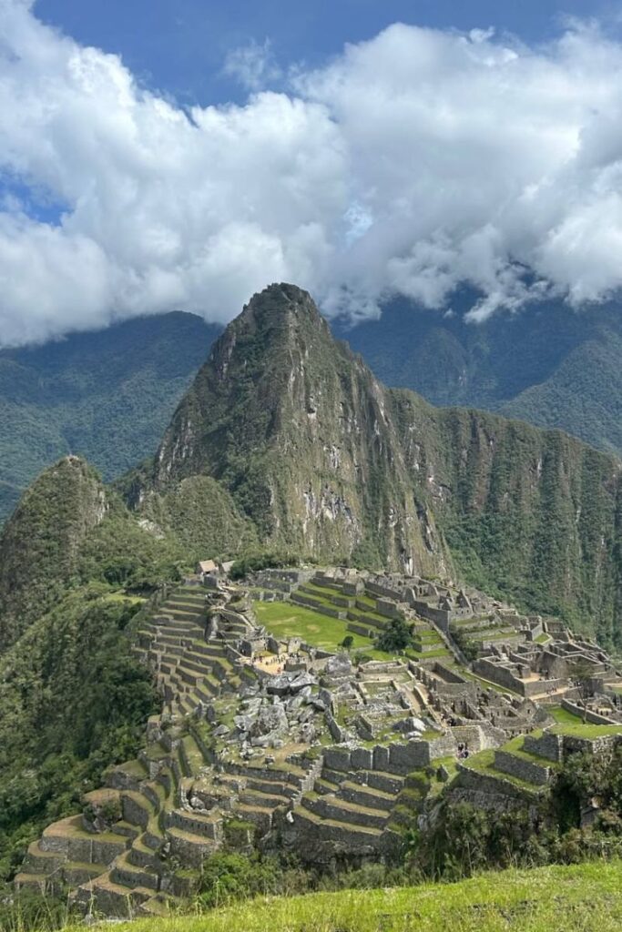 The ancient Incan city of Machu Picchu rises from the Andes under misty clouds—a dream trip for women traveling alone to South America, solo female travel Peru, and one of the best solo female travel destinations globally.