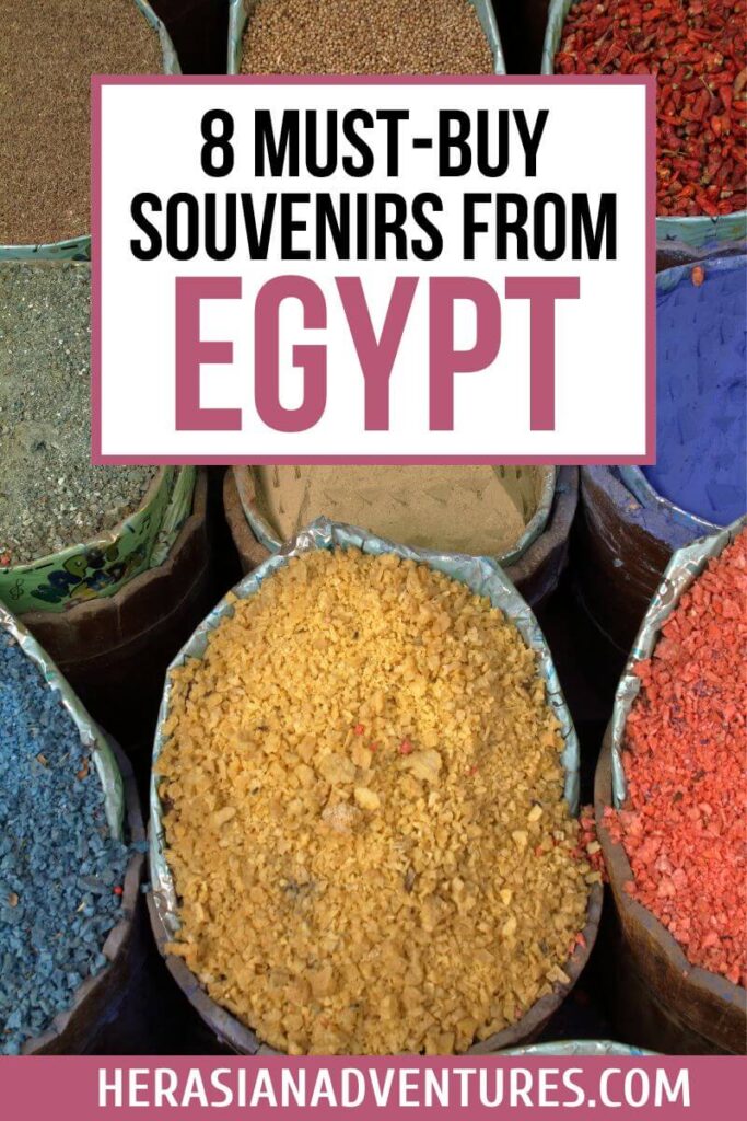 Eye-catching image with brightly colored spices in market bags, topped with text reading “8 Must-Buy Souvenirs from Egypt.” This photo showcases one of the best things to buy from Egypt—spices—making it perfect for travelers seeking popular souvenirs from Egypt and unique shopping experiences during Egypt travel.