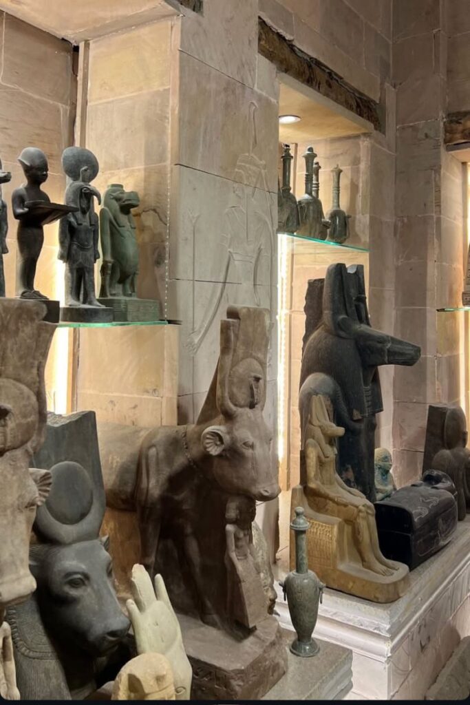 Rows of ancient Egyptian-style statues, including depictions of gods like Anubis, Hathor, and Horus, fill this stone-lined interior, evoking the grandeur of Egypt’s past. These museum-quality replicas are popular souvenirs from Egypt and reflect the appeal of historical souvenirs and Egyptian gift shop treasures. Great for tourists asking what to buy in Egypt that connects to its Pharaonic heritage.