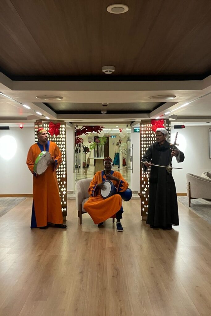Three men in traditional clothing performing live music on a cruise ship — tipping on a cruise ship in Egypt is customary. Learn when and how to tip entertainment staff.