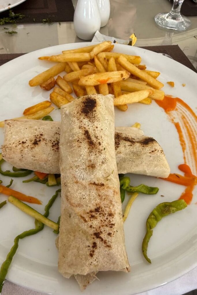 Plate of Egyptian-style wraps with fries — tipping in restaurants in Egypt is expected. This Egypt travel guide explains tipping etiquette and how to plan your budget for eating out.