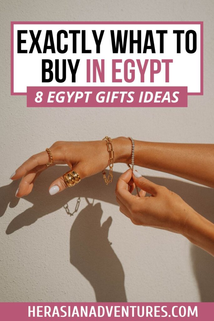 Elegant image of a woman’s hands showcasing several bracelets, rings, and chains, with a bold title overlay: “Exactly What to Buy in Egypt – 8 Egypt Gifts Ideas.” A perfect fit for travelers wondering what jewelry to buy in Egypt or where to buy gold in Egypt, highlighting Egyptian gold chains and fashion-forward gifts from Egypt.