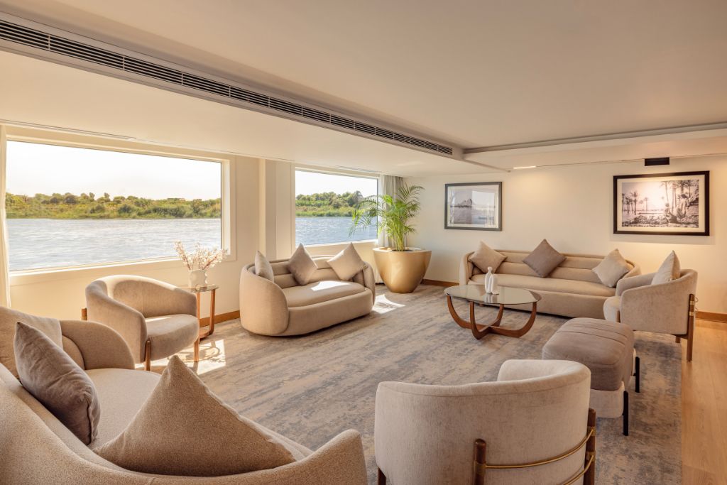 Bright and modern lounge area aboard a luxury Nile cruise ship with large panoramic windows overlooking the river. A relaxing feature often included in a 10 days Egypt itinerary or when planning how many days in Egypt for a scenic tour.