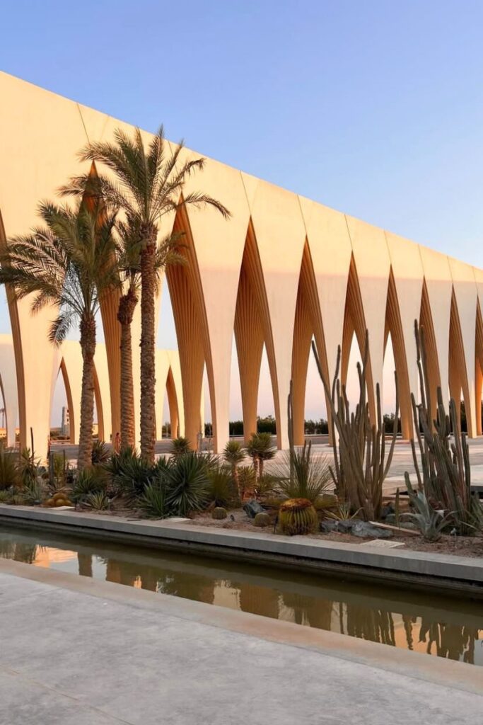 Striking contemporary architecture with pointed arches and desert plants in Hurghada, framed by clear skies and palm trees. This scenic and Instagrammable location is one of the best places to go in Hurghada and offers unique things to do in Hurghada Egypt for architecture lovers and explorers.