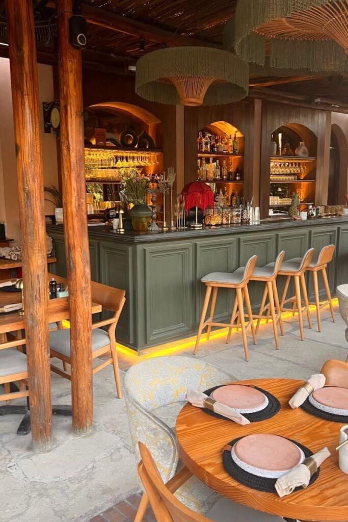 Warm, inviting interior of a modern restaurant bar in Hurghada with wooden furniture, soft lighting, and neatly set tables. This spot is ideal for romantic things to do in Hurghada Egypt and makes the list of the best things to do in Hurghada at night.