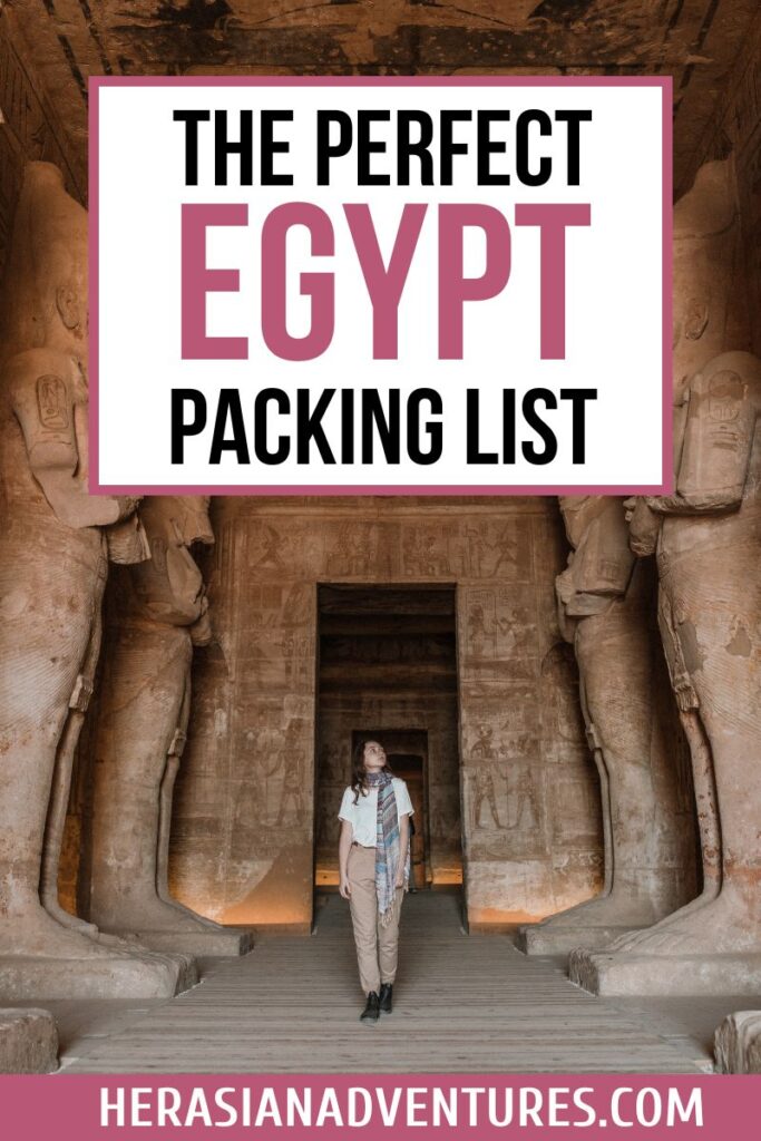 A solo traveler in modest pants, boots, and a scarf walks through the temple of Abu Simbel surrounded by colossal statues. The graphic includes overlay text that reads “The Perfect Egypt Packing List,” highlighting tips for what to pack for Egypt and creating the best packing for Egypt experience.