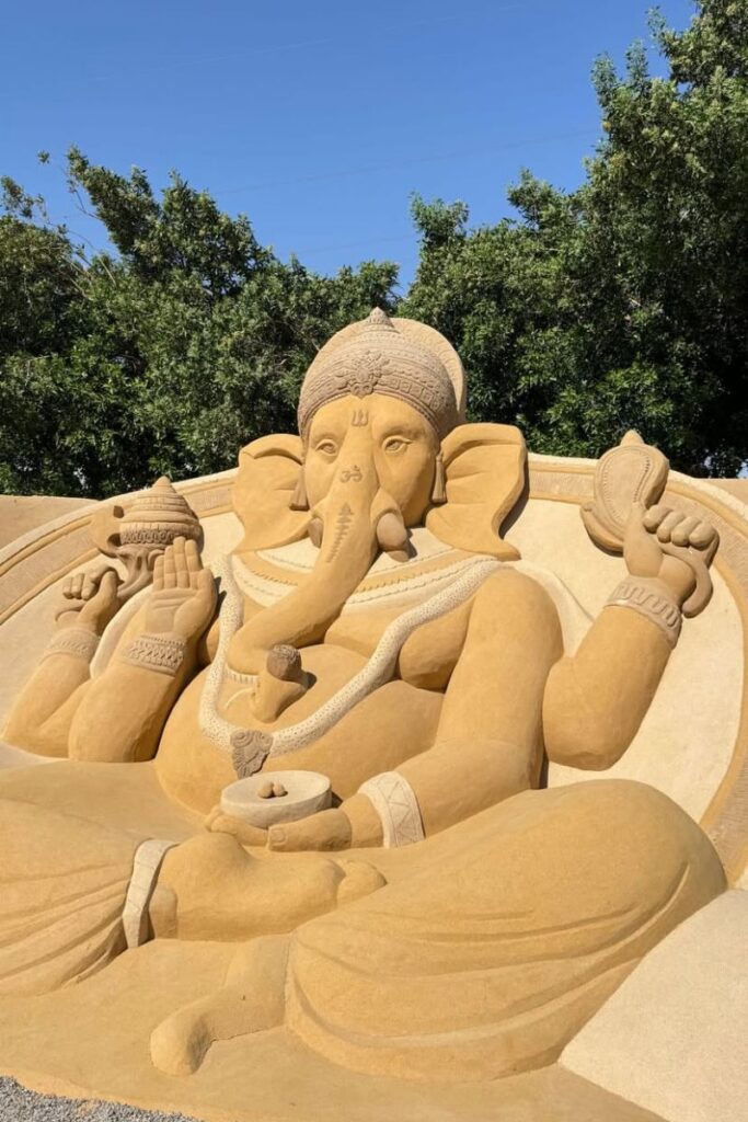 Intricate sand sculpture of the elephant-headed deity Ganesha, seated in a meditative pose with detailed carvings and symbols. Visiting this site is one of the unique things to do in Hurghada Egypt and adds spiritual variety to your list of Hurghada activities.