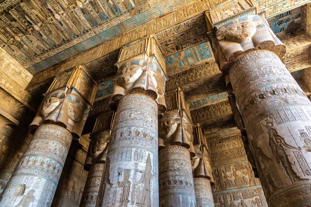 Ornate painted ceiling and massive decorated columns in Dendera Temple, Egypt – great for travel to Egypt tips, cultural appreciation, and things to know before visiting Egypt’s ancient temples and ruins.
