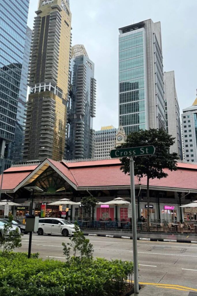 The historic Lau Pa Sat hawker centre with its red-tiled roof sits among Singapore’s towering modern skyscrapers. A must-visit foodie stop when comparing Hong Kong or Singapore street food.