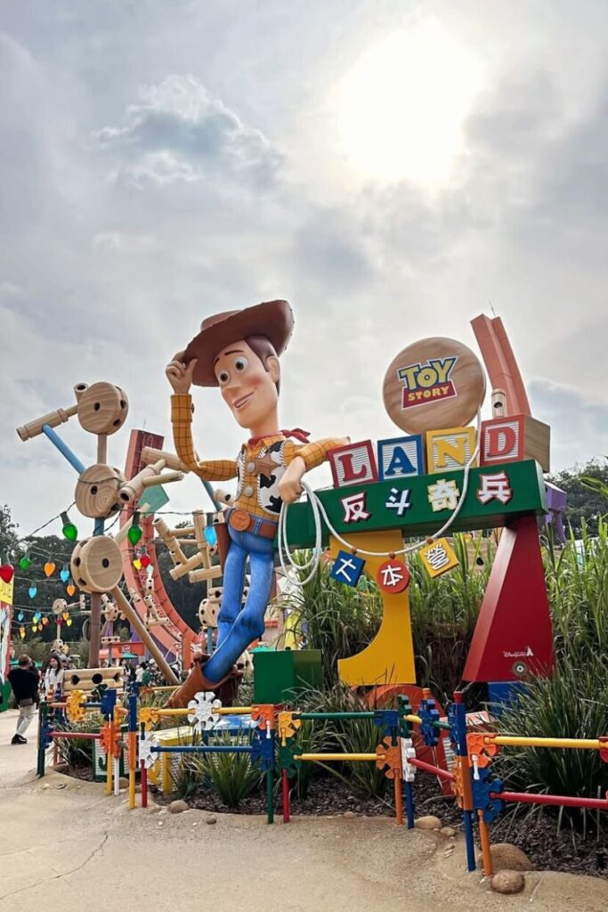 A giant Woody statue welcomes visitors to Toy Story Land at Hong Kong Disneyland with colorful decorations. This is a fun stop for families and one of the best things to know before going to Hong Kong Disneyland.