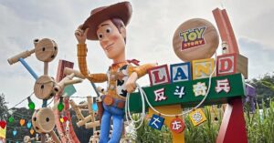 A towering Woody statue welcomes visitors to Toy Story Land, surrounded by colorful themed decor. This playful zone features some of the most exciting Hong Kong Disneyland rides and deserves a top mention in any detailed Hong Kong Disneyland review.