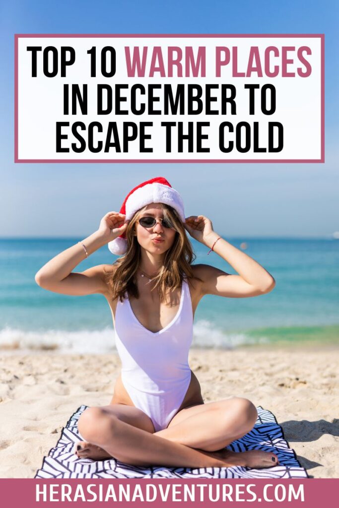 A woman wearing sunglasses and a Santa hat sits on a sunny beach, overlaid with text “Top 10 Warm Places in December to Escape the Cold.” This fun, festive image promotes winter vacations in warm countries and sunny December getaways.